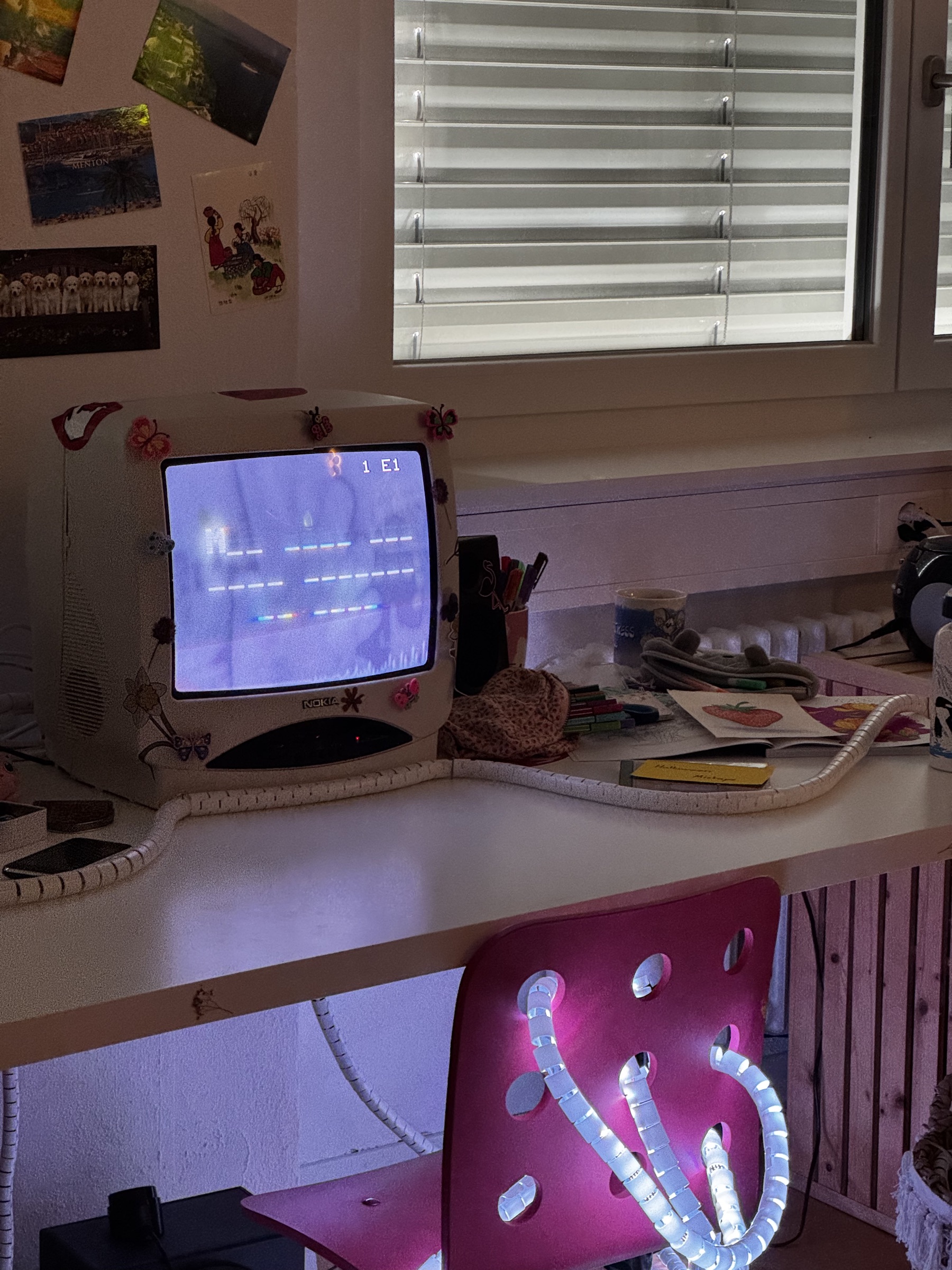 The CRT on the desk, with the LED strip running along the desk and up the chair.